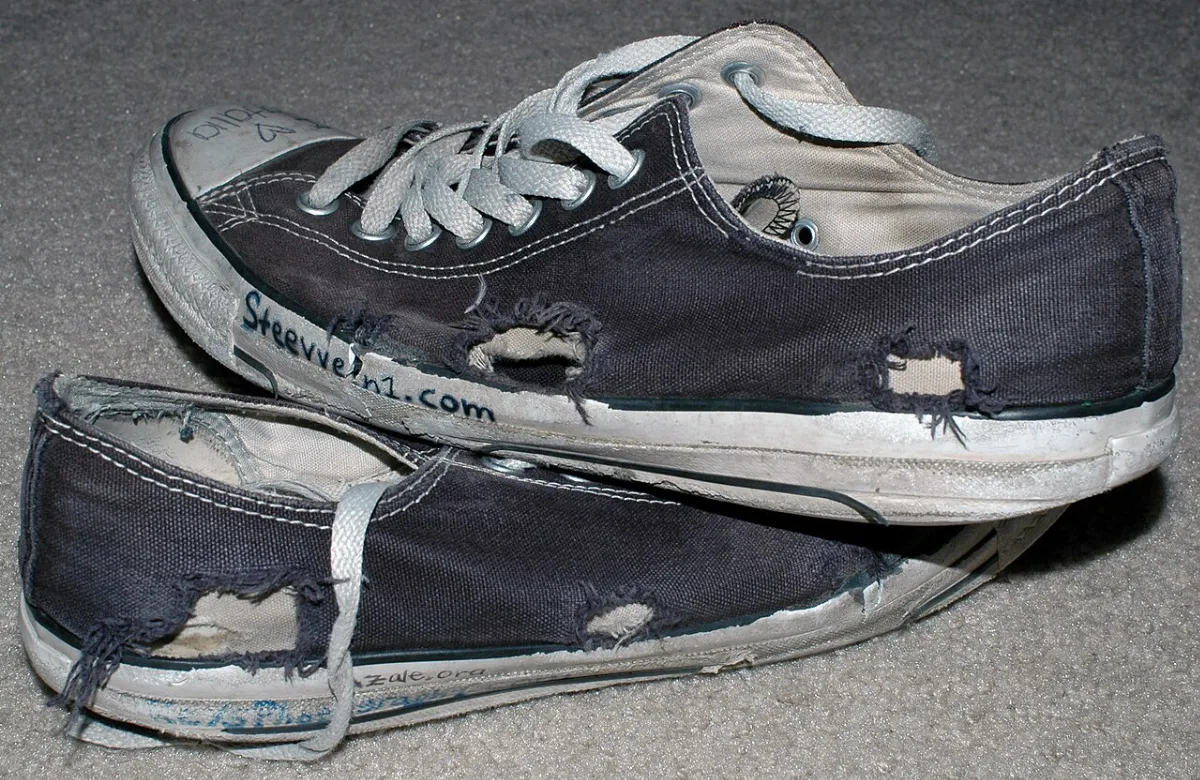 A well-worn pair of black Converse sneakers