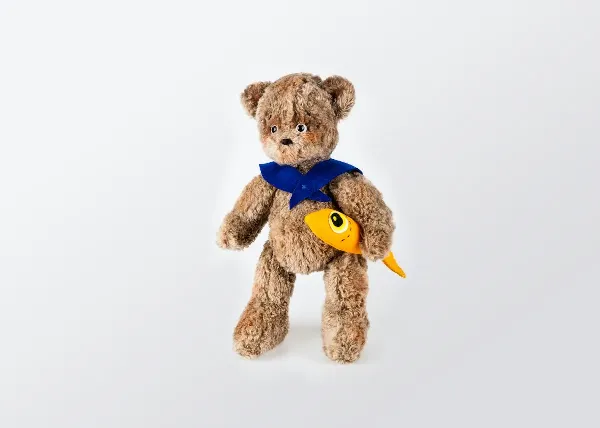 A brown teddy bear plush toy on a white background