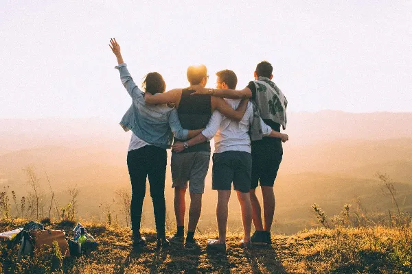 Silhouettes of a group of friends outdoors at sunset