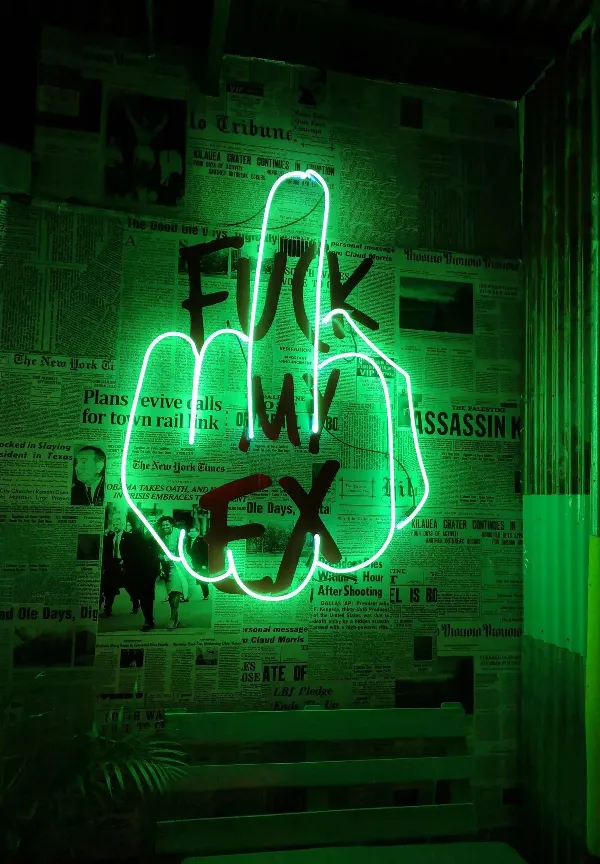A glowing green neon light sign