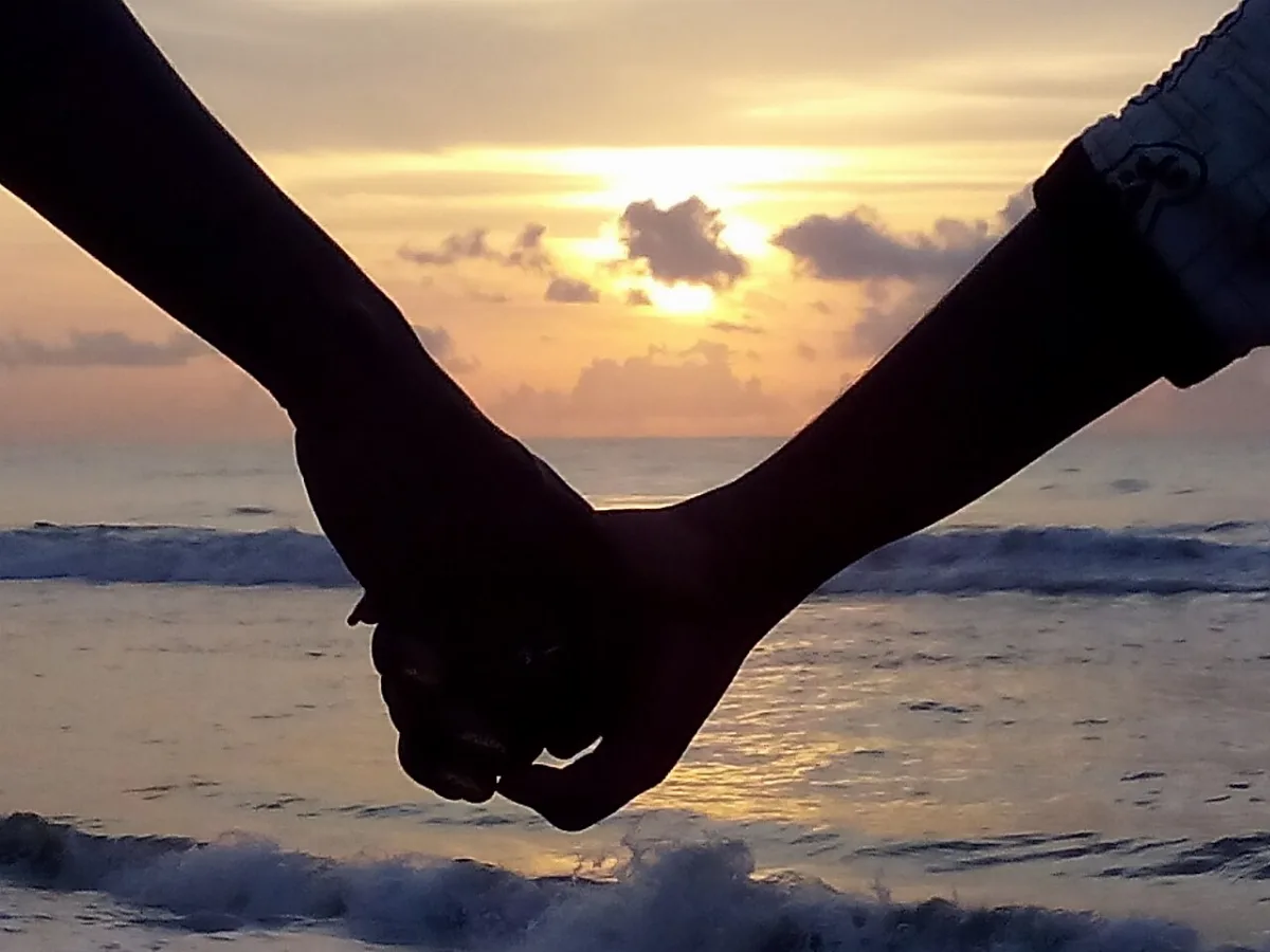 Two people holding hands