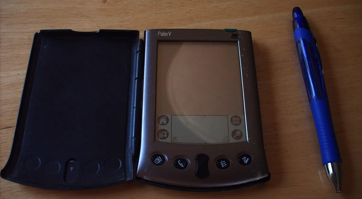 A Palm V handheld organizer with a thin metal case