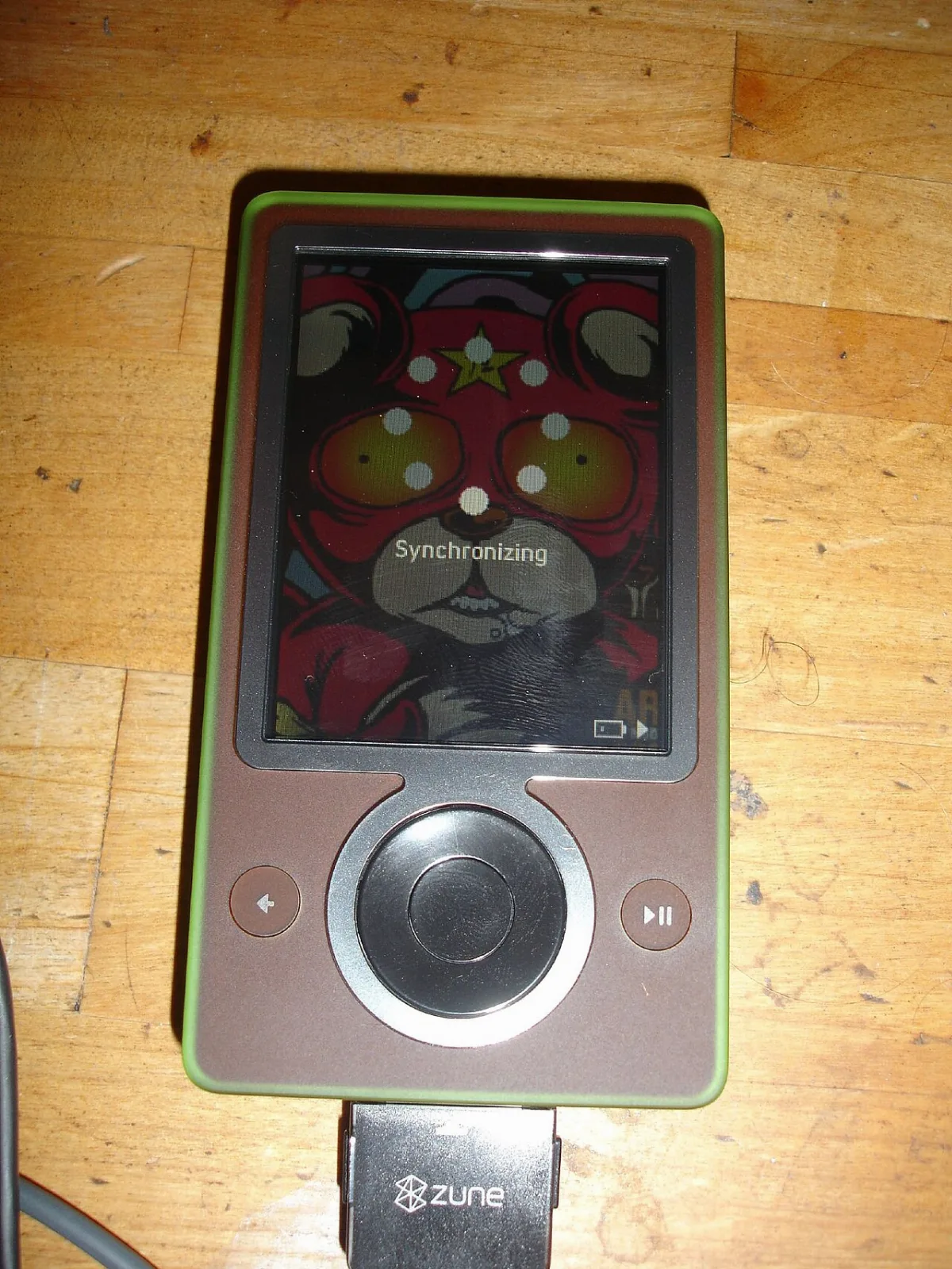 A brown Zune 30 music player with its click pad